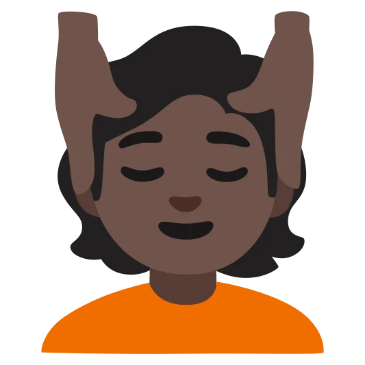The person getting massage: dark skin tone emoji.