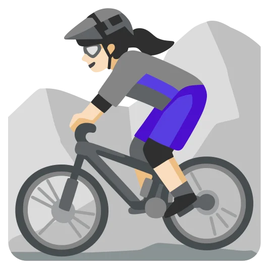 The woman mountain biking: light skin tone emoji.